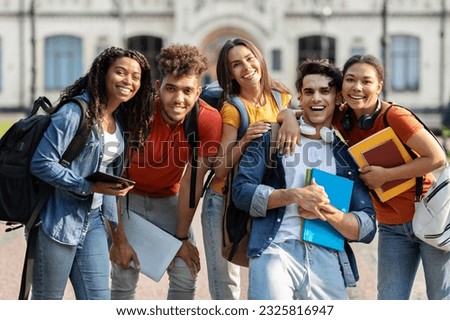 College Friendship Concept. Happy Multiethnic Group Of Students Posing Outdoors, Cheerful Young Muticultural Friends With Backpacks And Workbooks Embracing And Smiling At Camera, Closeup Royalty-Free Stock Photo #2325816947