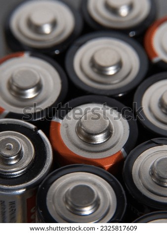 Closeup of pile of used alkaline batteries. Close up colorful rows of selection of AA batteries energy abstract background of colorful batteries. Alkaline battery aa size. Several batteries in rows Royalty-Free Stock Photo #2325817609