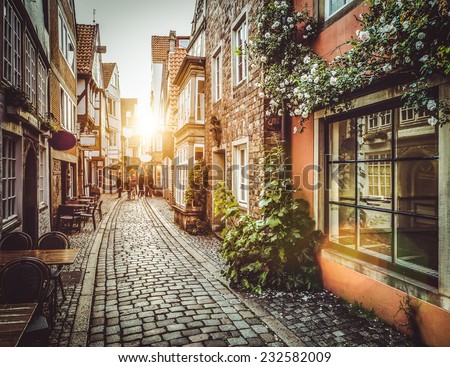Old town in Europe at sunset with retro vintage Instagram style filter and lens flare effect Royalty-Free Stock Photo #232582009