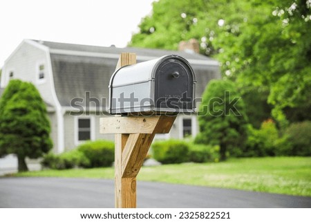 mailbox stands tall against a backdrop of greenery, symbolizing communication, connection, and the exchange of thoughts and emotions Royalty-Free Stock Photo #2325822521