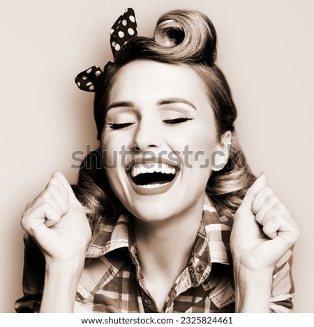 WOW! Unbelievable news! Excited surprised very happy yell rockabilly woman. Astonished pinup girl with open mouth and closed eyes raised rising hands fists. Retro vintage concept. Monochrome bw photo Royalty-Free Stock Photo #2325824461