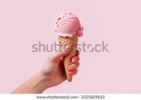 female Hand holding strawberry ice cream cone Royalty-Free Stock Photo #2325829633