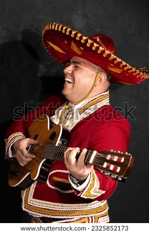 Mexican mariachi musician on a black background	