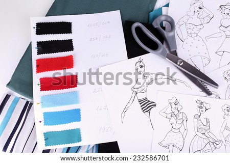 Sketches of clothes and fabric samples on table