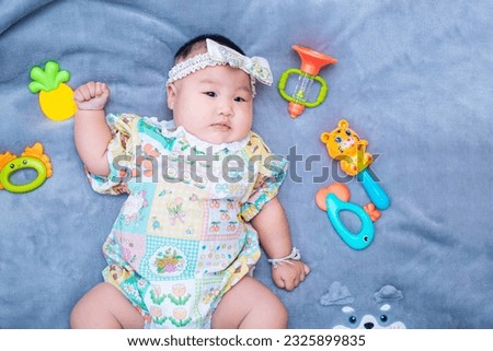 baby boy in floral dress,little baby girl six months old in a cute outfit and a bow on her head