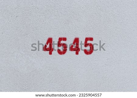 Red Number 4545 on the white wall. Spray paint.
