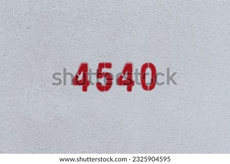 Red Number 4540 on the white wall. Spray paint.
