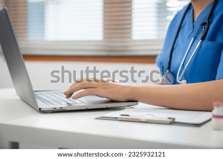 Medical technology network team meeting concept. doctor hands typing on keyboard laptop computer. Royalty-Free Stock Photo #2325932121