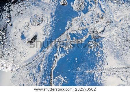 Picture of a spring concealing ice floe close up with cracks and bubbles.