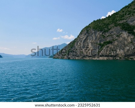 Panoramic view of scenic road in cliff overlooking Lago d'Iseo, Castro, Italy. High quality photo Royalty-Free Stock Photo #2325952631