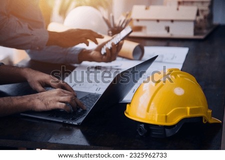 Construction and structure concept of Engineer or architect meeting for project working with partner and engineering tools on model building and blueprint in working site, contract for both companies. Royalty-Free Stock Photo #2325962733