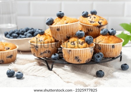 Healthy vegan banana blueberry muffins with fresh berries Royalty-Free Stock Photo #2325977825