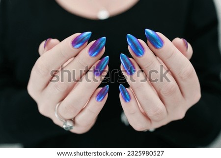 beautiful female hand with long nails, purple and blue manicure  Royalty-Free Stock Photo #2325980527