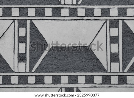 Sgraffito or graffito decorations on the wall give the impression that the walls are built out of large pyramid shaped stones Royalty-Free Stock Photo #2325990377