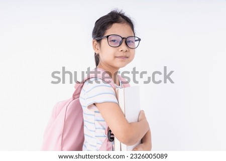 Very cute Asian girl carrying a pink backpack back to school to study, learning at school on a white background. Learning concept, back to school.