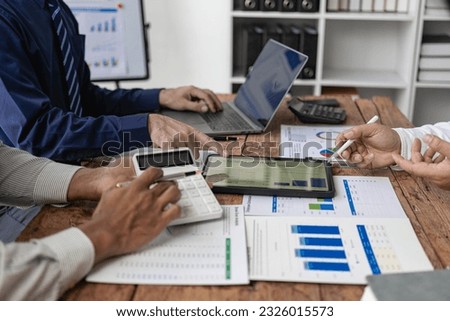 Business concept,Business people analyzing investment charts accounting.Closeup group of Asian business people meeting discuss project plan and financial results in office. Royalty-Free Stock Photo #2326015573