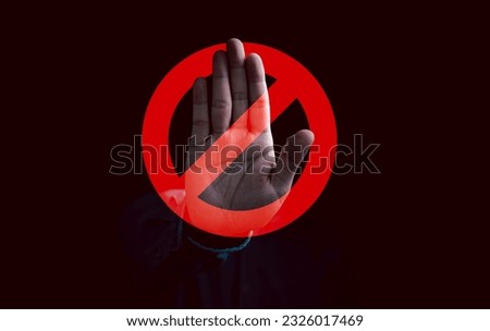 Hand showing gesture with red stop sign. Royalty-Free Stock Photo #2326017469