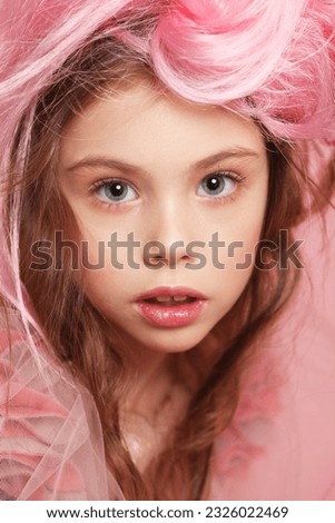 Pretty child girl in a pink dress, like a princess, pink hair and makeup