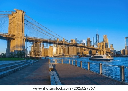 Manhattan's skyline with Brooklyn bridge, cityscape of New York City in the United States of America at sunrise