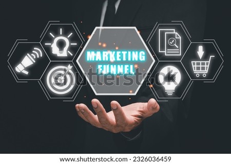 Marketing funnel concept, Business person hand holding marketing funnel icon on virtual screen. Royalty-Free Stock Photo #2326036459