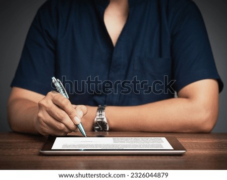 Digital contract signing. Businessman signing a digital contract on a modern tablet adopting digitalization which eliminates paperwork and streamlines corporate operations. Signature electronic.