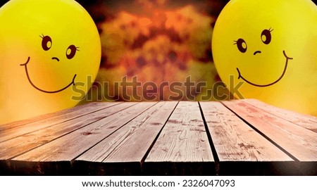 Wood floor or plank table, counter with yellow balloons and smile cartoon face. Empty space for text. Layout for the presentation of the product. Holiday and Birthday