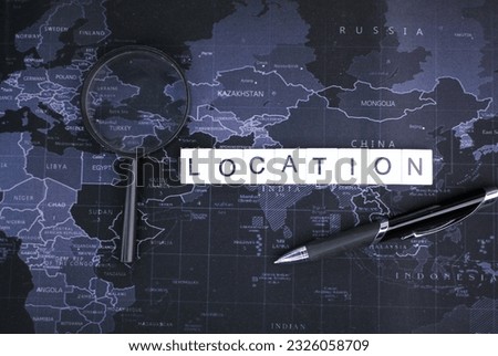 Pen, magnifying lens with alphabetical location. The concept of finding locations
