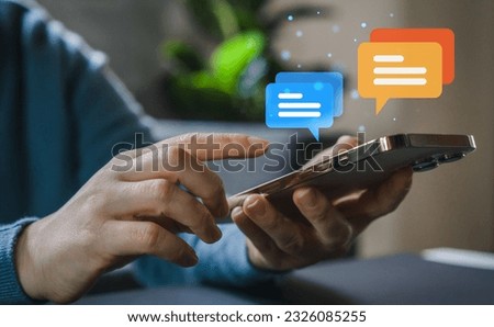 Human hand using smartphone typing Live chat chatting and social network concepts, chatting conversation working at home in chat box icons pop up. Social media marketing technology concept Royalty-Free Stock Photo #2326085255