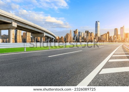 Asphalt road and urban skyline with modern buildings at Chongqing, China.