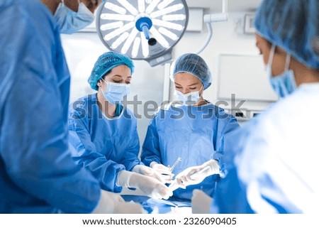 Doctor and assistant nurse operating for help patient from dangerous emergency case .Surgical instruments on the sterile table in the emergency operation room in the hospital.Health care and Medical Royalty-Free Stock Photo #2326090405