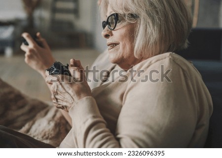 Side view of young female in casual clothes and eyeglasses sitting in armchair and looking away