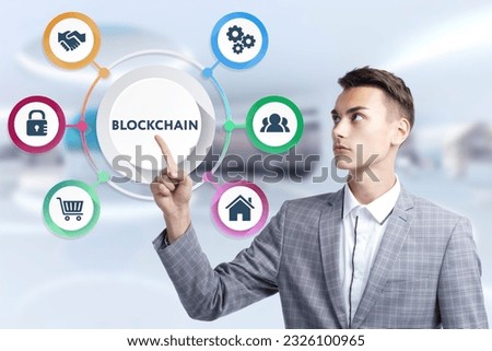 Business, Technology, Internet and network concept. Young businessman working on a virtual screen of the future and sees the inscription: Blockchain Royalty-Free Stock Photo #2326100965