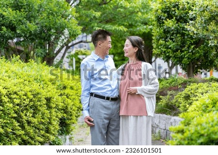 Japanese couple standing in the fresh green