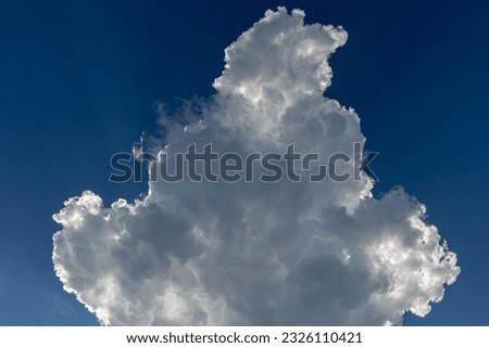 Cumulonimbus cloud formation over blue sky.