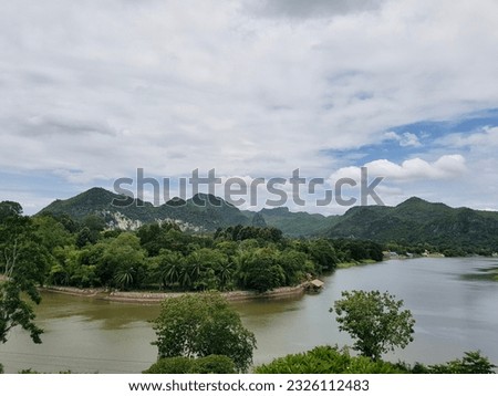 a view of a river and mountains from a hill
