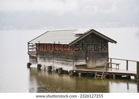 wooden house on the lake in the Austrian Alps. house on the shores of a mountain lake. Alpine house in the high beautiful mountains.