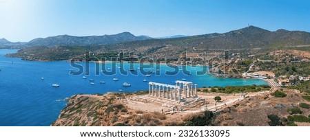 Panoramic view of the Temple of Poseidon at Cape Sounion at the edge of Attica, Greece, with moored sailboats in the bay during summer time Royalty-Free Stock Photo #2326133095