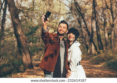 Young couple taking selfie in the park