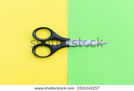 Scissors placed on colored papers, after some edits.