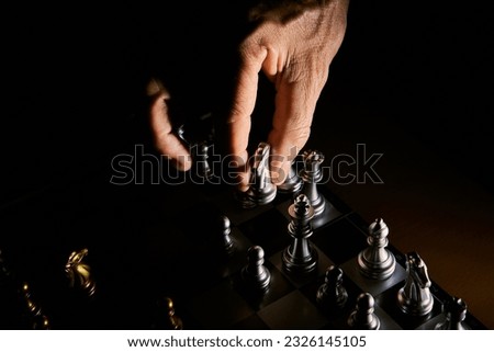 hand of businessman  wearing suit moving chess using strategic challenge idea  ,  business competition planing teamwork strategic concept.