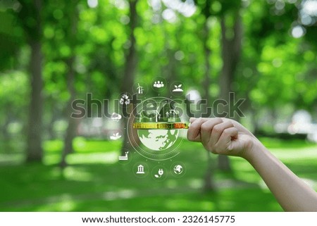 ESG Environmental, Social and Governance in Sustainable and Ethical Business Networking ecosystem icon on a magnifying glass Focus on developing green energy concepts.