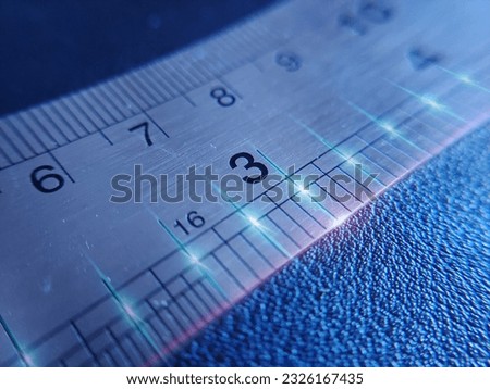The number three or 3. Macro photography of stainless steel ruler image with laser light style