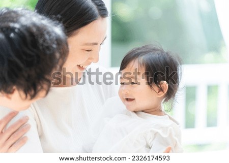 Smiling Asian family of three