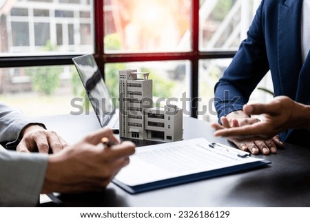 The home broker recommends the client to sign the contract,Real estate concept.Real estate agents are recommending to provide information about housing to customers. Buy house, real estate concept. Royalty-Free Stock Photo #2326186129