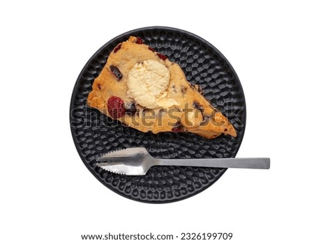 Homemade Vanilla Mixed Cream Cheese Granberry Scone served with spoon on black ceramic plate isolated on white background with clipping path. The concept of delicious dessert, Top view.