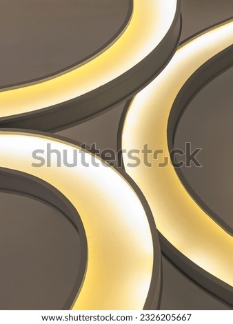 The interior modern round lamp fixtures when looking up to the ceiling illuminate warm light room. Architecture and interior lighting design, Abstract lighting background, Copy space, Selective focus.