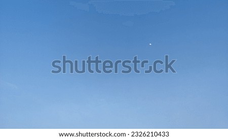 A photograph of sky with sun and clouds