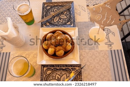 Wrinkled potatoes with mojo picón, typical dish of Canarian food, accompanied with beers, Gran Canaria, Spain