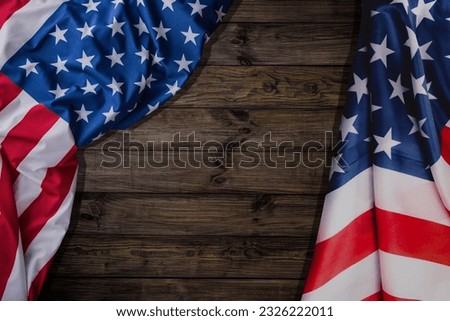 American flag on brown wooden background. USA star-spangled banner. Memorial Day. 4th of July. Independence day. Veterans day. Waving flag design for poster, flyer, greeting card, invitation.