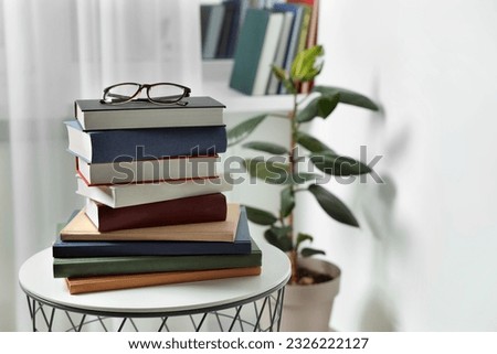 Stack of many different books and glasses on coffee table indoors. Space for text Royalty-Free Stock Photo #2326222127